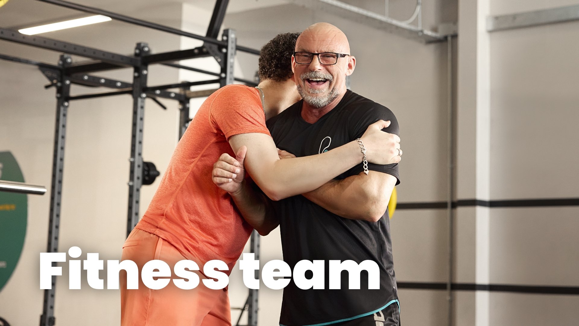 Two men hugging, Fitness team in the gym.